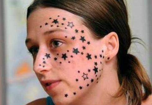 Dozens of tiny stars facial tattoo.