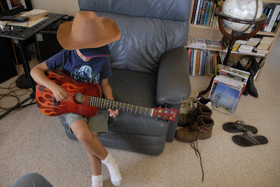 boy in office playing little guitar