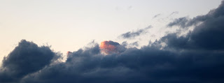 A cloud catches the last rays of light