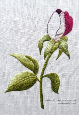 Using a gel pen to mask the previous guidelines on an thread painted (embroidered) rosebud (design by Trish Burr)