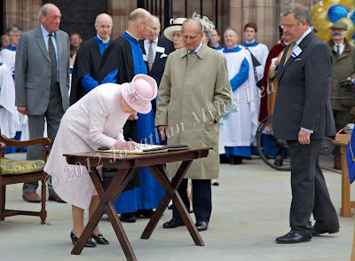 HM The Queen signing a book at Hereford Cathedral. Photo © Jonathan Myles-Lea