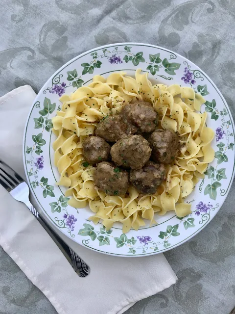 Bowl of Swedish meatballs on egg noodles.