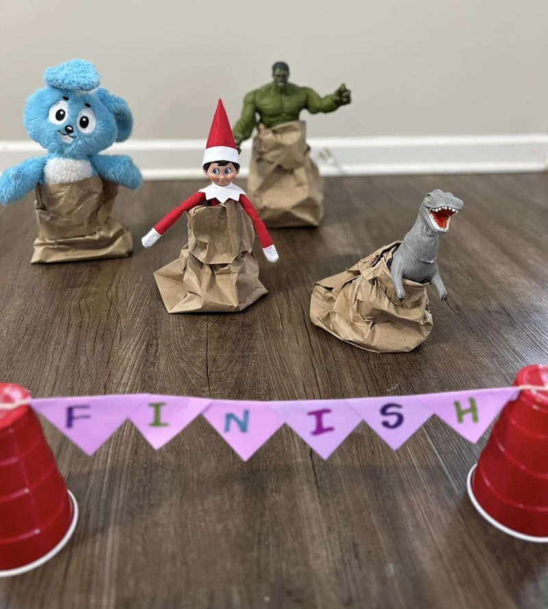 elf and toys having a sack race.