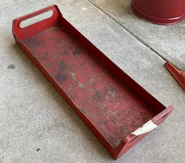 Photo of a red painted metal garage tray