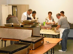 Prepping the meal at the Saffron Fair, Preuilly sur Claise.  Indre et Loire, France. Photographed by Susan Walter. Tour the Loire Valley with a classic car and a private guide.