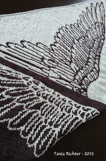 A fabric piece with a detailed black and white wing pattern.