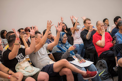 Applause in sign language — showing solidarity with Anthony Chong and the Deaf audience members.