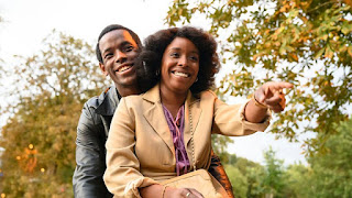 Two people smiling in a park