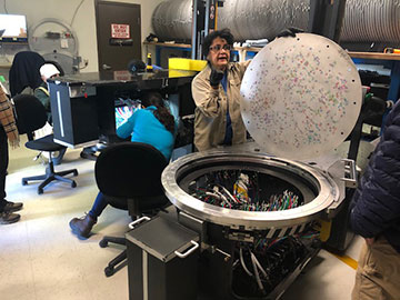 Technicians preparing and plugging fiber optic cables in disk for use that evening (Source: Palmia Observatory)