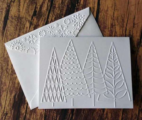 all-white embossed Christmas trees card with embossed snowflakes on envelope flap