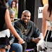 Kanye West grins as he checks out models in college fashion show