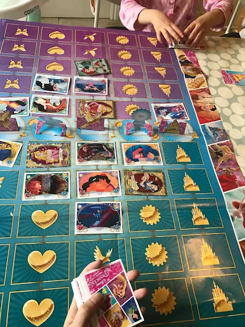 Side 2 of the Disney Princess Trading Card Game game mat with cards in place and the stand up cards across the middle