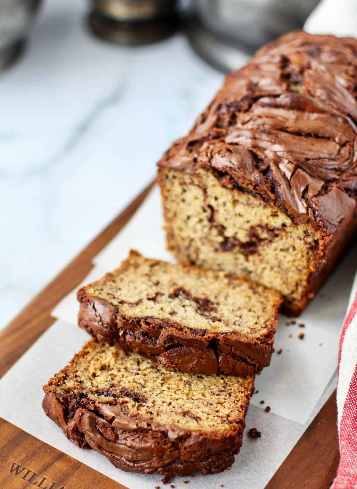 Banana Bread with Swirls of Nutella on a cutting board.