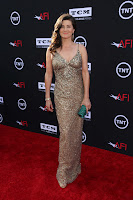 Daphne Zuniga in a shiny gown on the red carpet