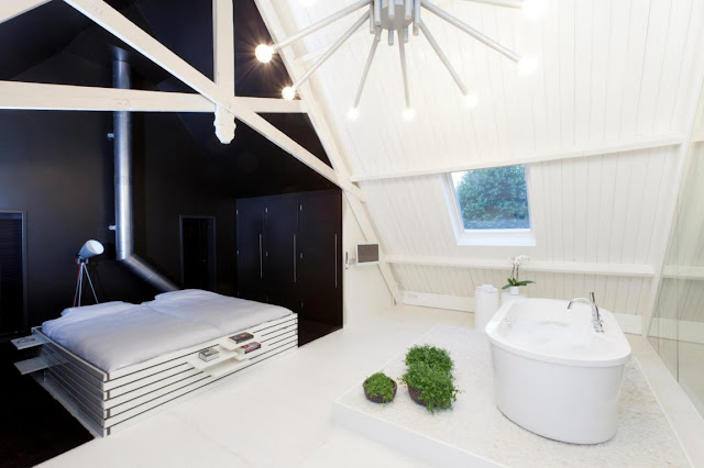 Picture of modern bed and white bathtub 