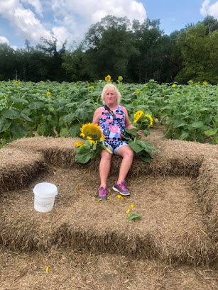 Sitting on haystack with Sunflowers