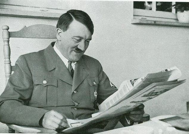 Adolf Hitler reading newspaper worldwartwodaily.filminspector.com