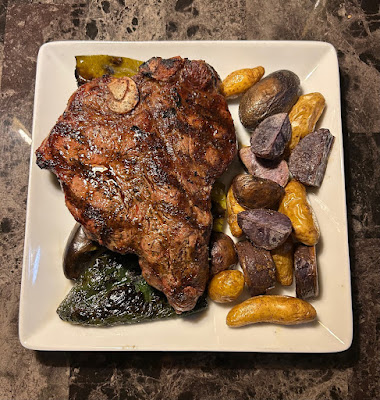 Rare grilled porterhouse with roasted potatoes, poblanos and hatch chiles