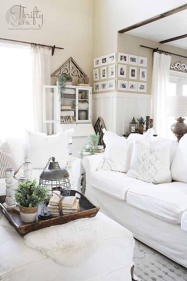 farmhouse style spring living room decor. Spring living room decorating ideas. White and woods living room decor. spring decorating ideas for the home. Two story living room decor. Ikea ektorp couches. Spring mantle decorating ideas. Neutral living room decor