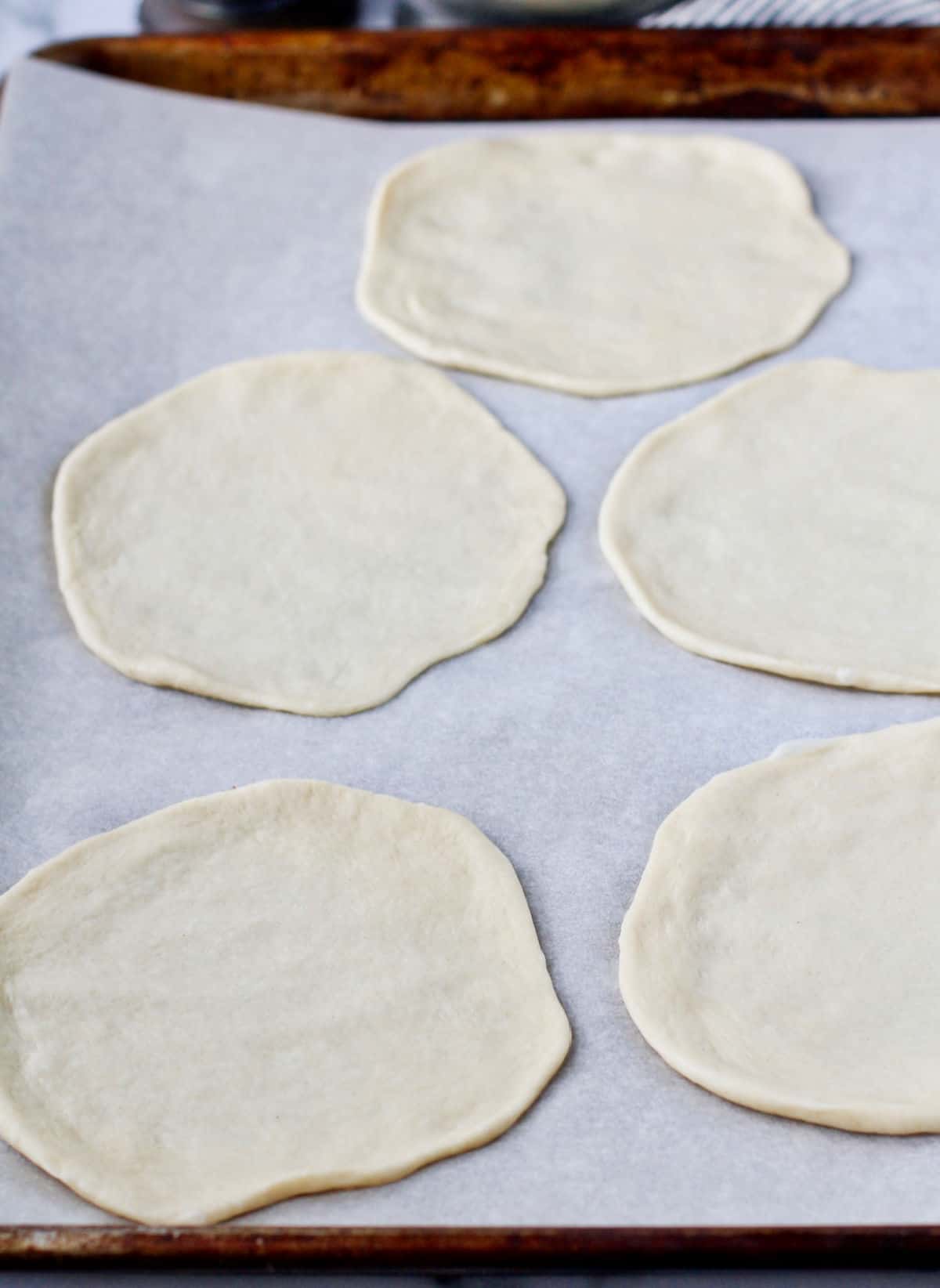 Mini Pizza Mummy dough rolled out on a baking sheet.