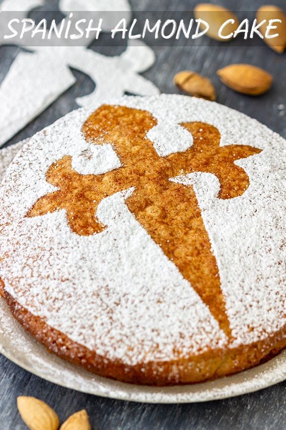 Spanish Almond Cake is a rich flourless dessert that is popular all over Spain. To make this sweet treat you only need 5 simple ingredients. It’s also naturally gluten-free! #happyfoodstube #spanish #almond #cake #dessert #almondcake #flouerless #glutenfree #tartadesantiago