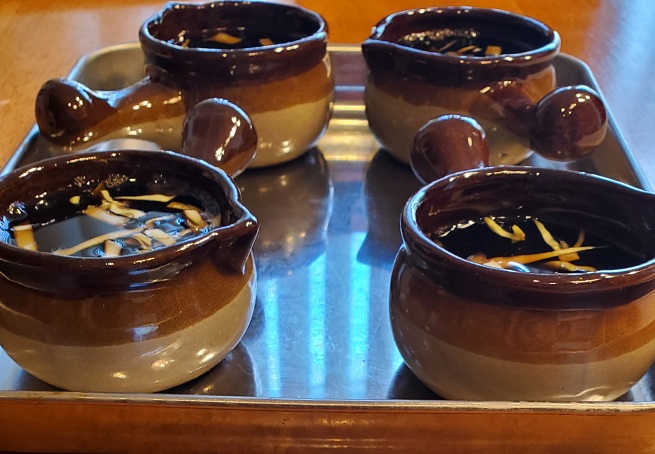 these are little ramekin brown pots with onion beef broth inside