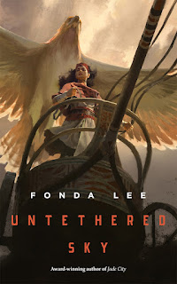 A woman stands on a wooden chariot, a large raptor flies above her, blocking out the sky