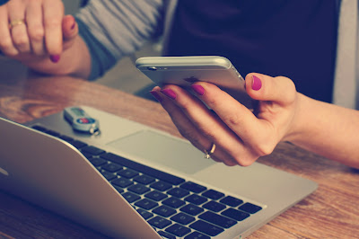 Photo of notebook computer and cell phone user