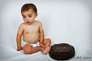 baby with a chocolate cake