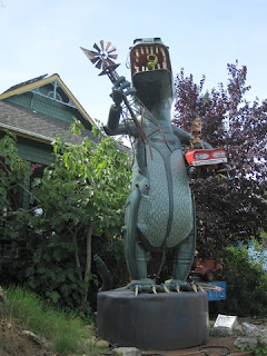 Godzilla clutching an Aermotor and a red convertible, by Patrick Amiot and Brigitte Laurent, Florence Avenue, Sebastopol, California