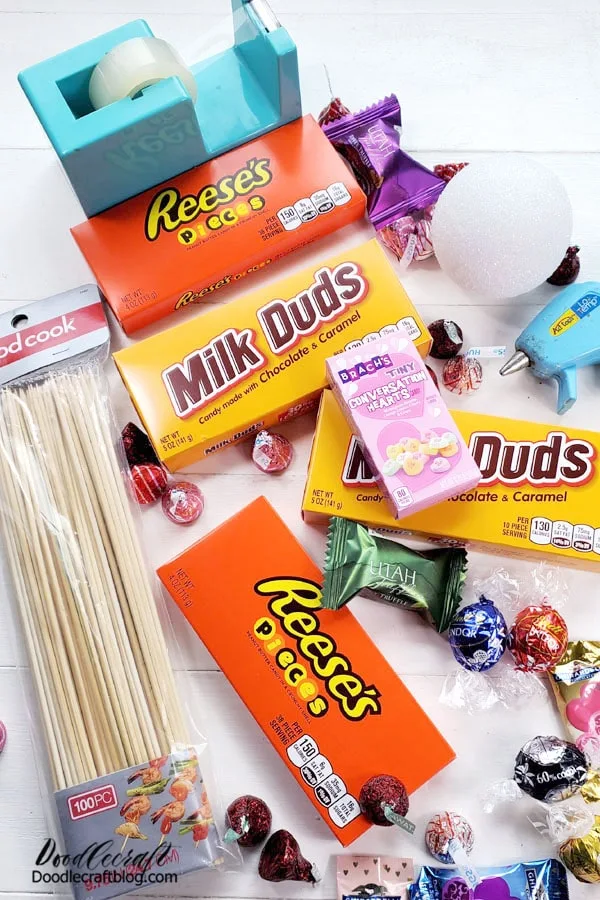 Supplies Needed for Valentine Candy Bouquet: 4 Large Movie Box Candies Wooden Skewers Hot Glue/Gun Tape Candy Styrofoam Ball Piece of cardboard for the base