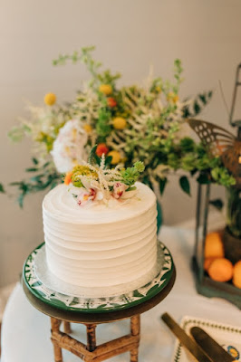 one tier white wedding cake with ribbed siding and floral on top