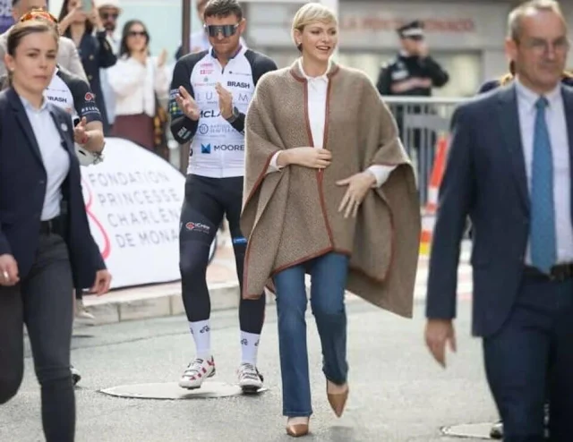 Princess Charlene wore a Sydney leather trim cashmere knit poncho by Loro Piana. COCC 10th annual St Tropez to Monaco Charity bike ride