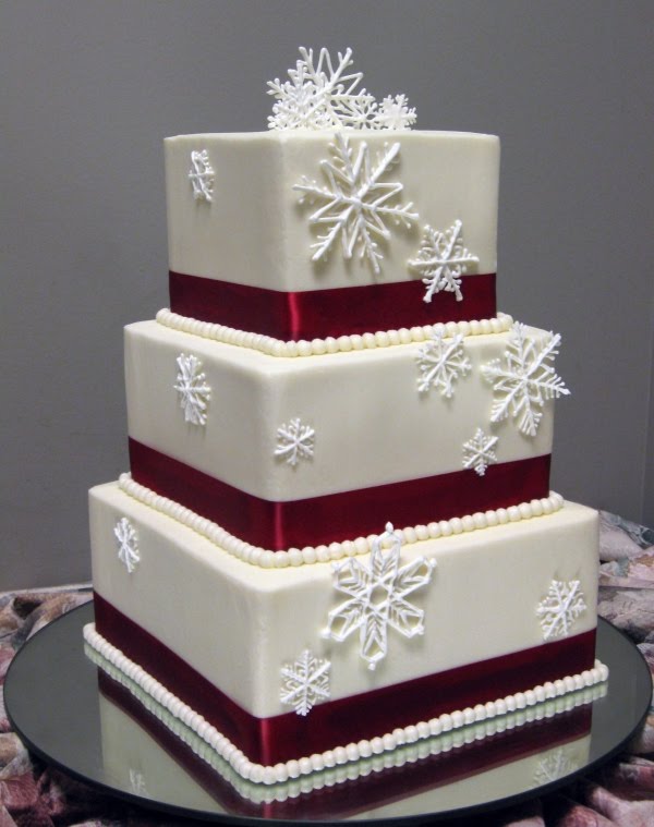 This wedding cake is decorated with sugar snow flakes and beautiful red