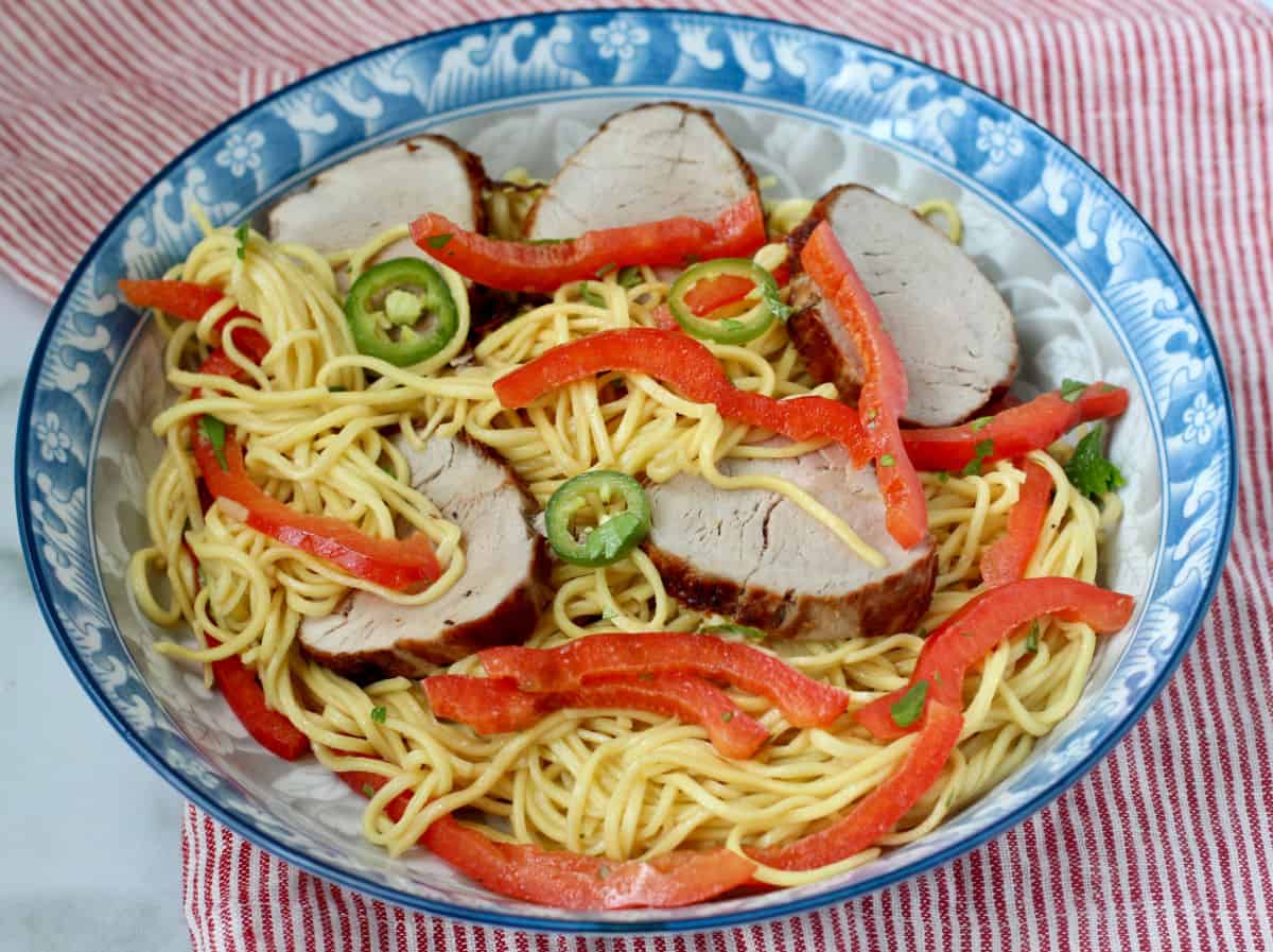 Chinese Egg Noodle Salad with Pork in a blue Asian-style print bowl.
