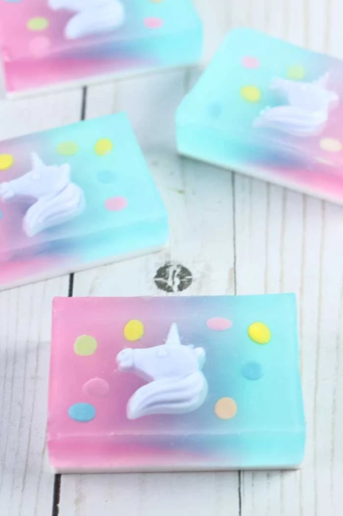 How to make a fun unicorn soap with melt and pour soap. Learn how to use unicorn embeds to make an awesome bar of soap that is great for kids or for gifts. Make a DIY soap with a natural fruity fragrance or use essential oils.  How to make handmade soap with this tutorial for a gradiant background. This fun designs can be used to make other products. Use a unicorn and rectangle mold for this recipe. Learn a new soapmaking technique. #soapmaking #unicorn