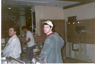 Jim looks into the camera (next to Greg, with Nate in the background) as the old Record Den empties out once and for all.