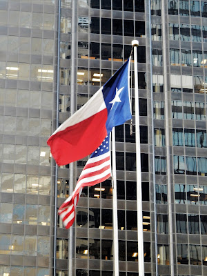 US and Texas flags on McKinney Street - Downtown Houston TX