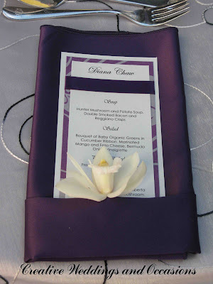 A single white cymbidium orchid was placed on each menu card adding that 