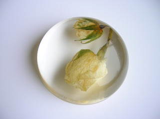 A resin paperweight containing preserved wedding flowers
