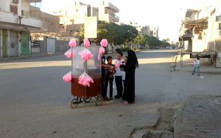 Syrian children buy cotton candy in Raqqa