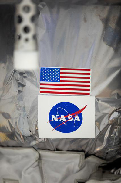The American flag and NASA's meatball logo on display aboard Astrobotic's Peregrine lunar lander at the Astrotech Space Operations facility in Titusville, Florida...on November 14, 2023.