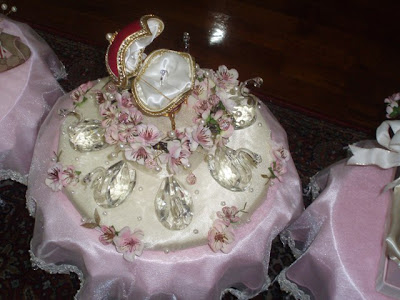 The wedding ring on a mini dais accompanied by crystal swans