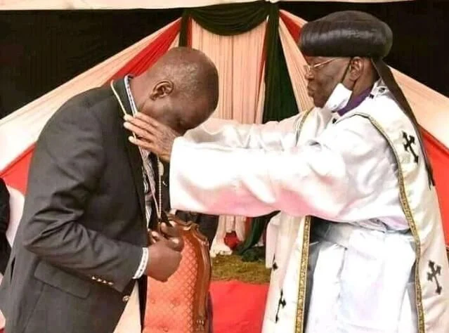 Deputy President William Ruto with Father John Pesa in Sugoi