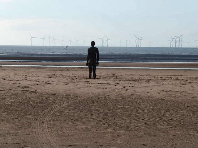 Statue looking out to Burbo Bank Offshore Wind Farm