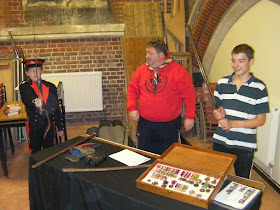 baloo scout leader with cubs and scouts meeting sword and medals exhibition for remembrance sunday