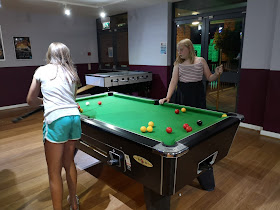 Tween girls playing pool