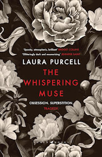 Book "The Whispering Muse" by Laura Purcell. All monochrome. Around the edges of the cover we see flowers in shades of white and grey. In the centre, a dark space - the black background - over which are the author's name (in white) and the title (in red) and the words "Obsession. Superstition. Tragedy".
