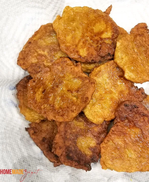 Pumpkin fritters sitting on a papertowell to remove excess oil