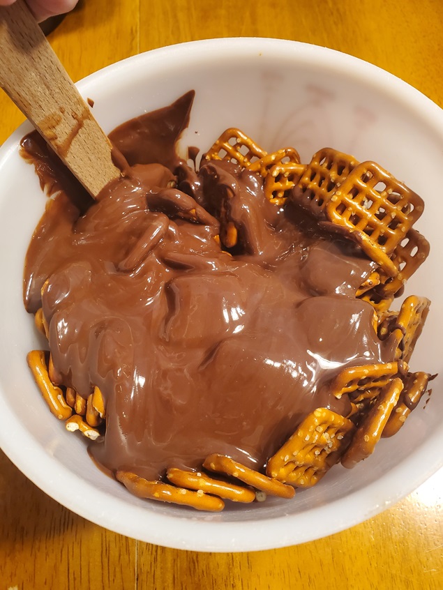 chocolate melted with peanut butter over pretzel squares